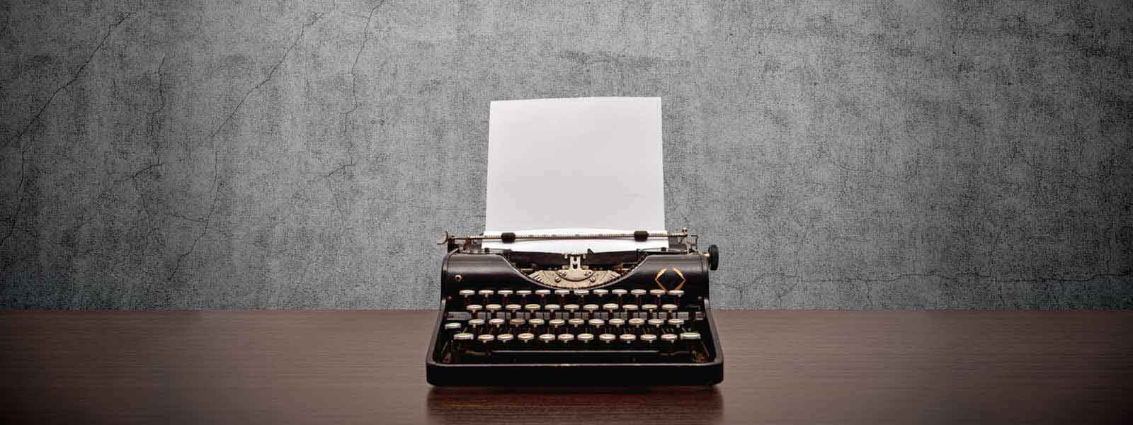 Typewriter and white paper symbolizes engaging content